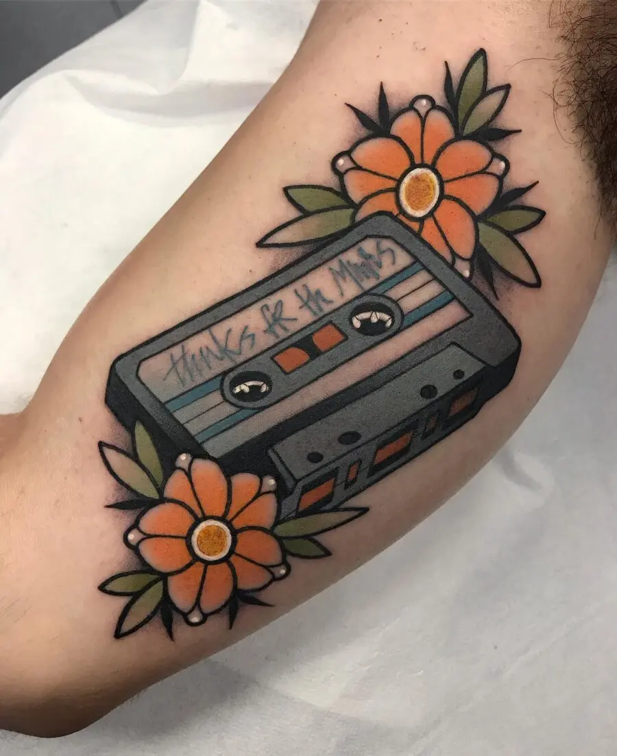 Colorful cassette tattoo adorned with flowers