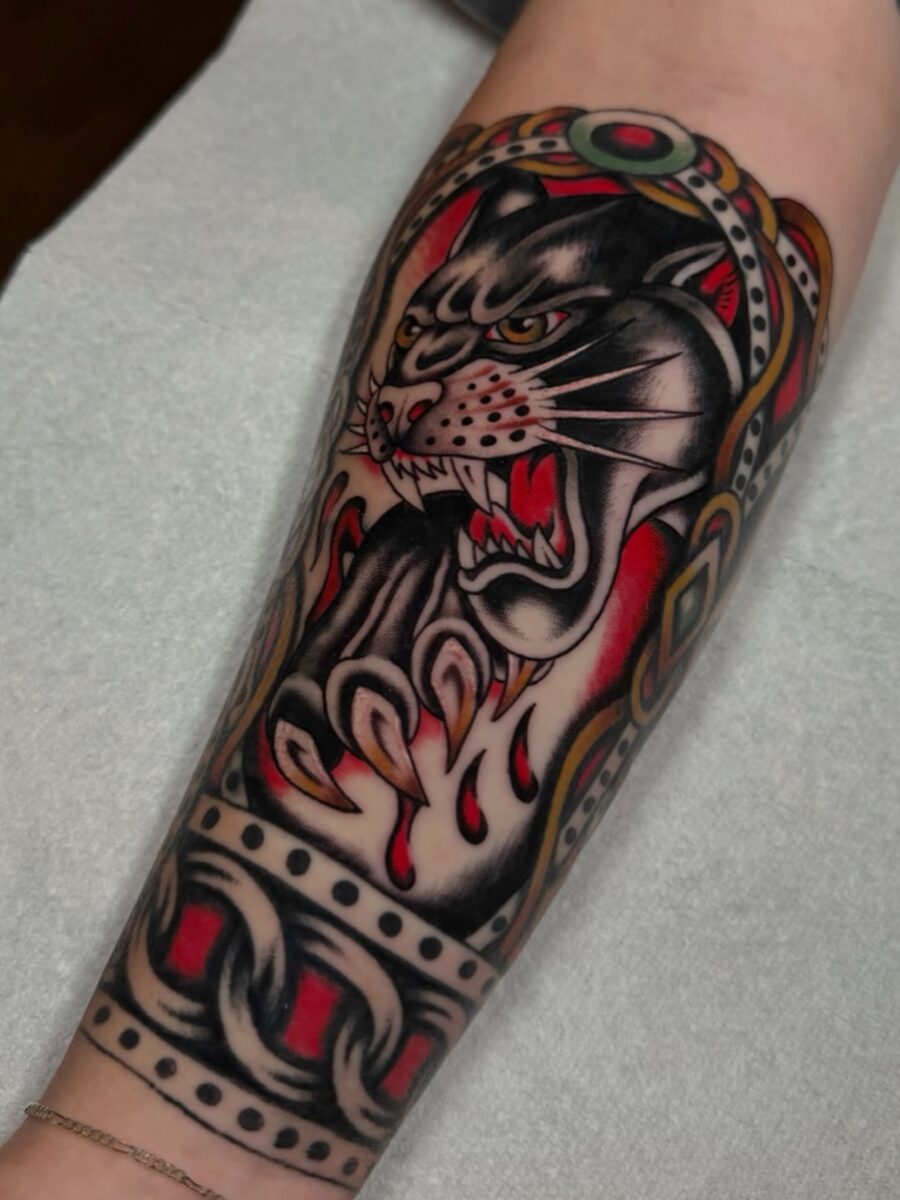 Bold half sleeve tattoo featuring a fierce panther