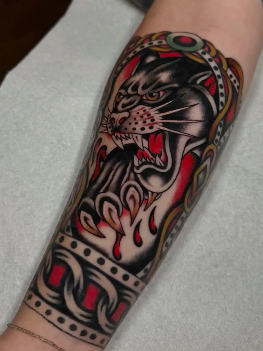 Bold half sleeve tattoo featuring a fierce panther