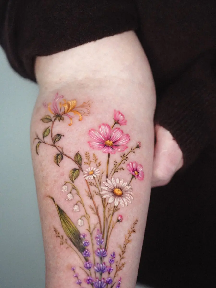 Vibrant floral tattoo showcasing birth flower meanings