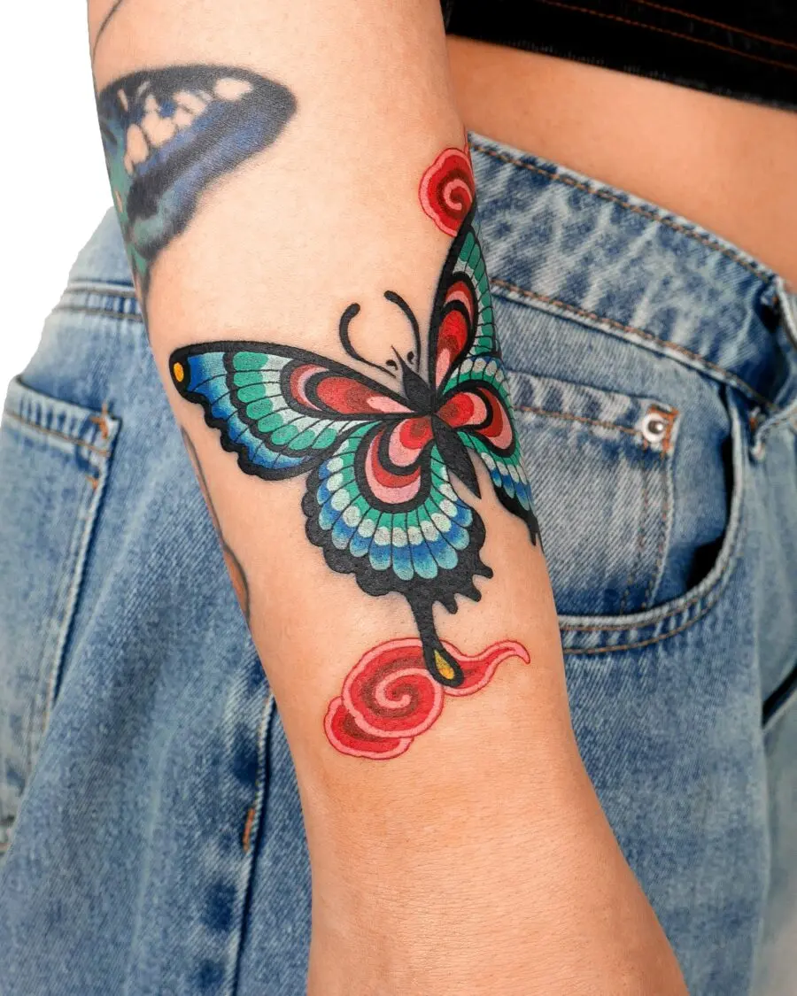Vivid butterfly tattoo with swirling accents