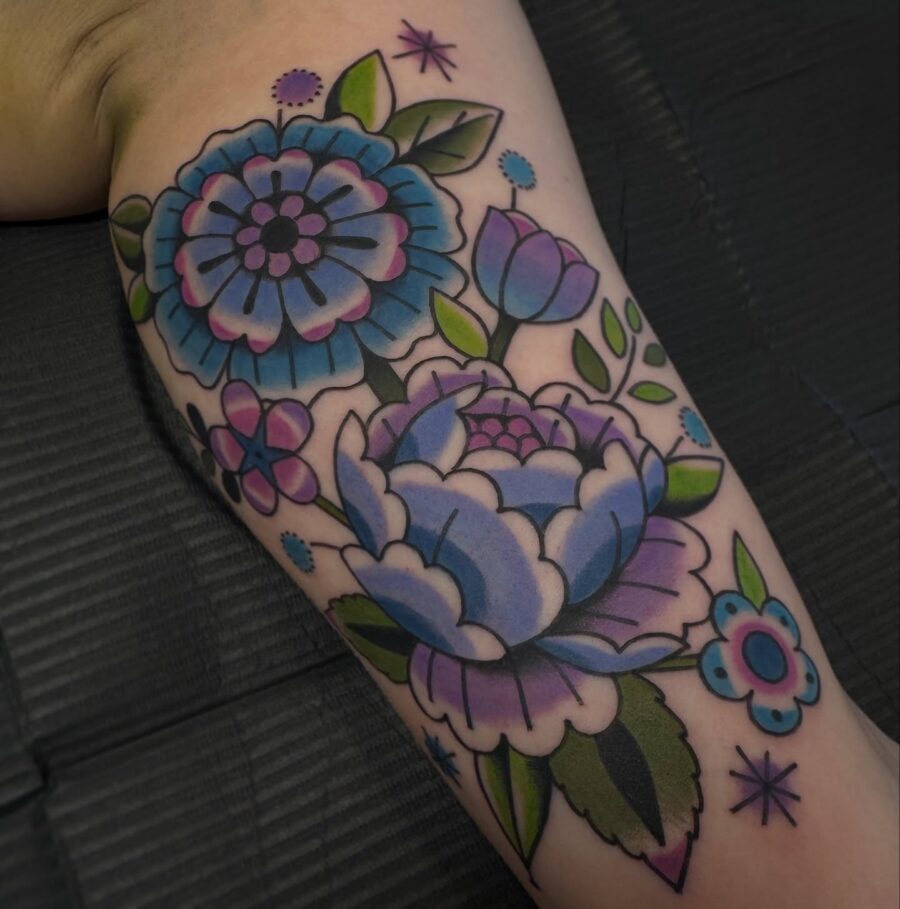 Vibrant floral biceps tattoo design for aesthetics