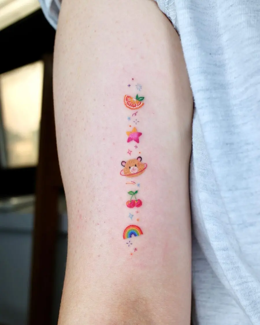 Charming rainbow baby tattoo with playful elements