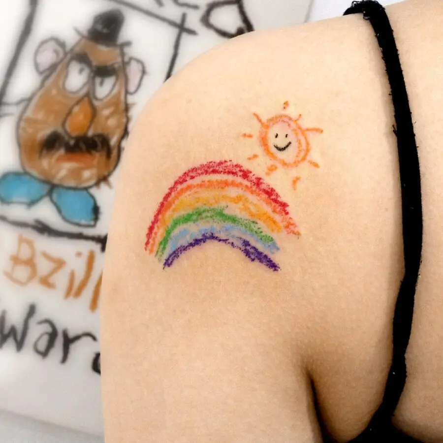 Colorful rainbow baby tattoo with sun imagery