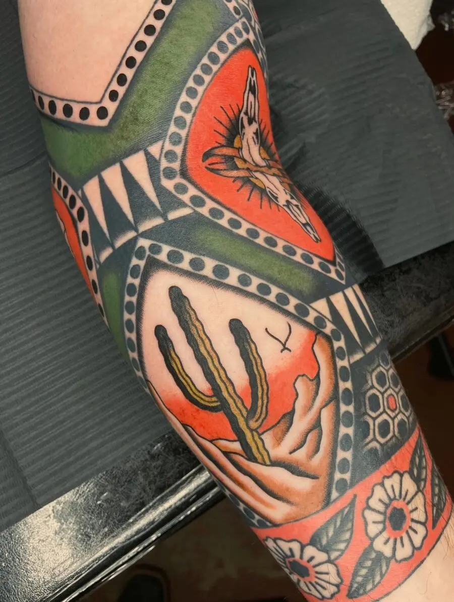 Vibrant western tattoo with desert elements