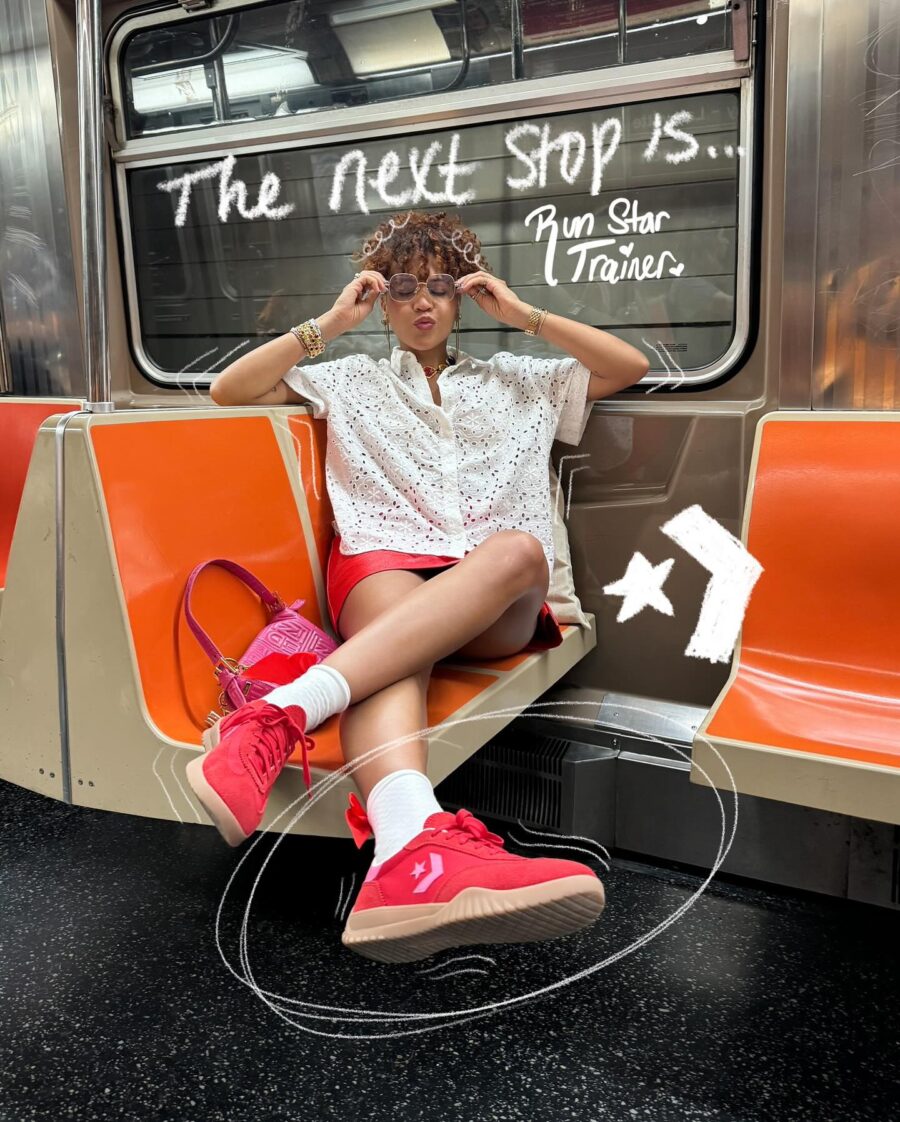 Chic subway style featuring red Converse trainers
