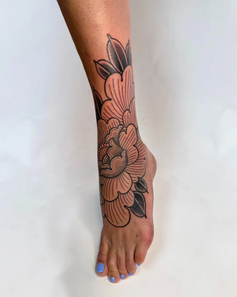 Elegant floral cover-up tattoo on the leg