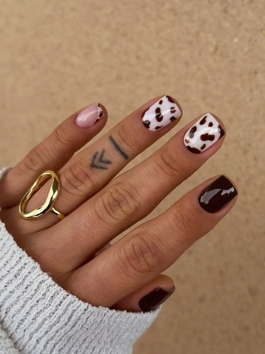 Stylish cow print nails with chic accents