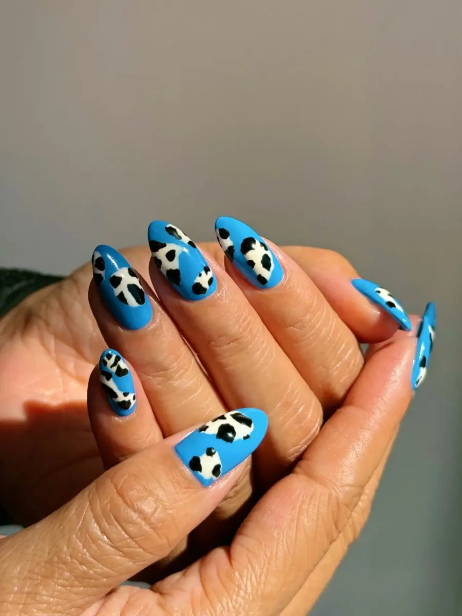 Chic cow print nails with a blue twist