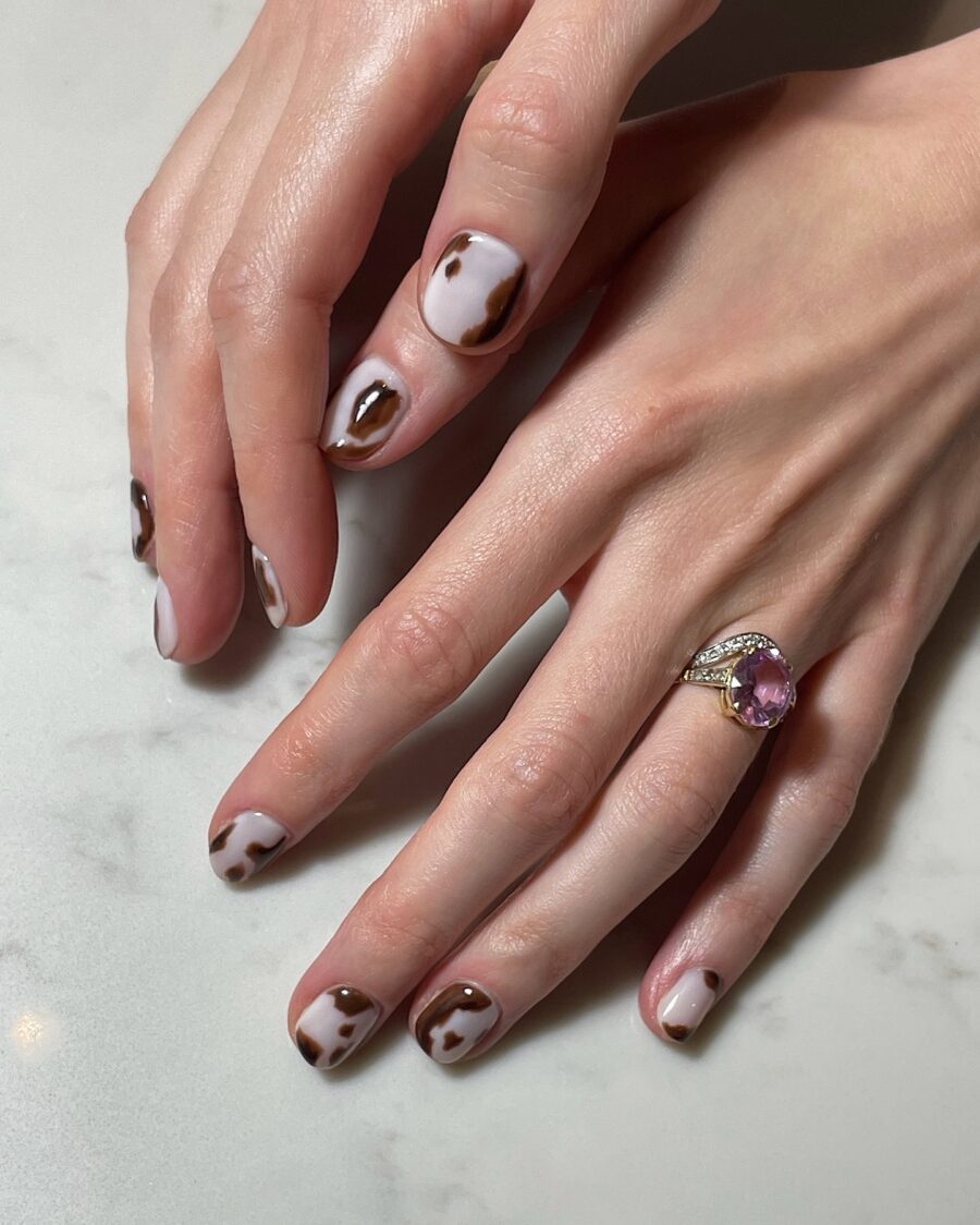 Chic cow print nails add playful elegance