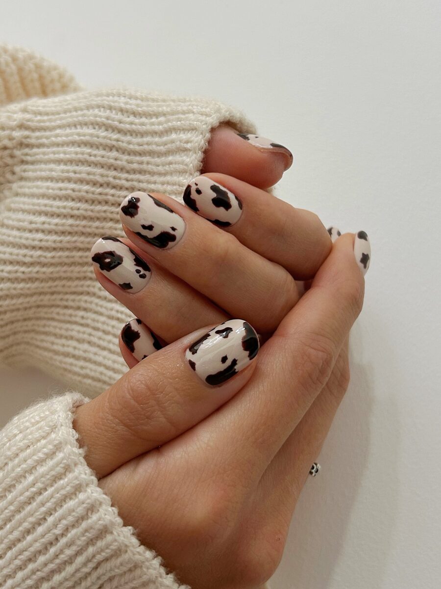 Stylish cow print nails with warm tones