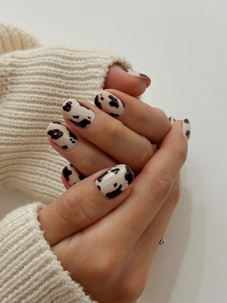 Stylish cow print nails with warm tones