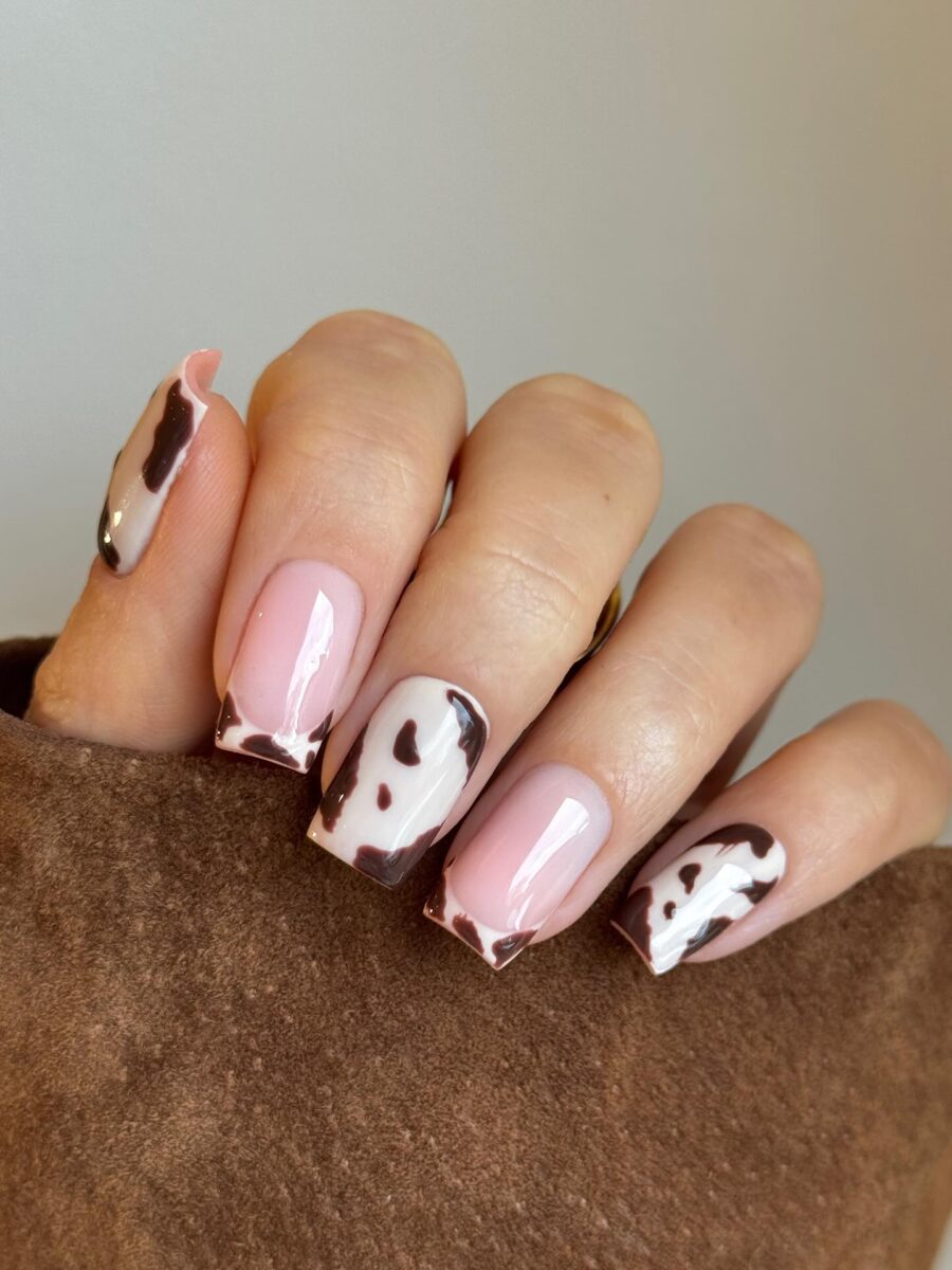 Chic cow print nails with a pink twist