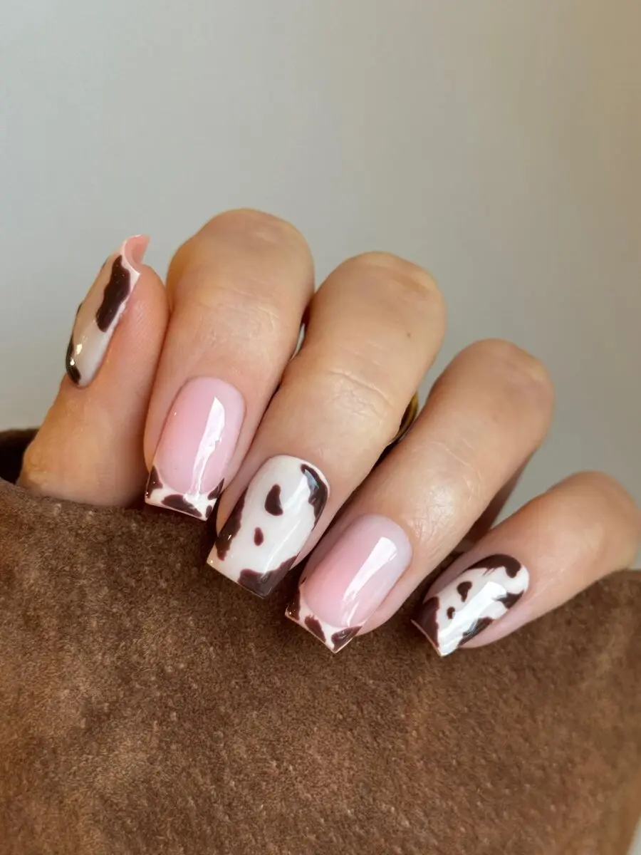 Chic cow print nails with a pink twist
