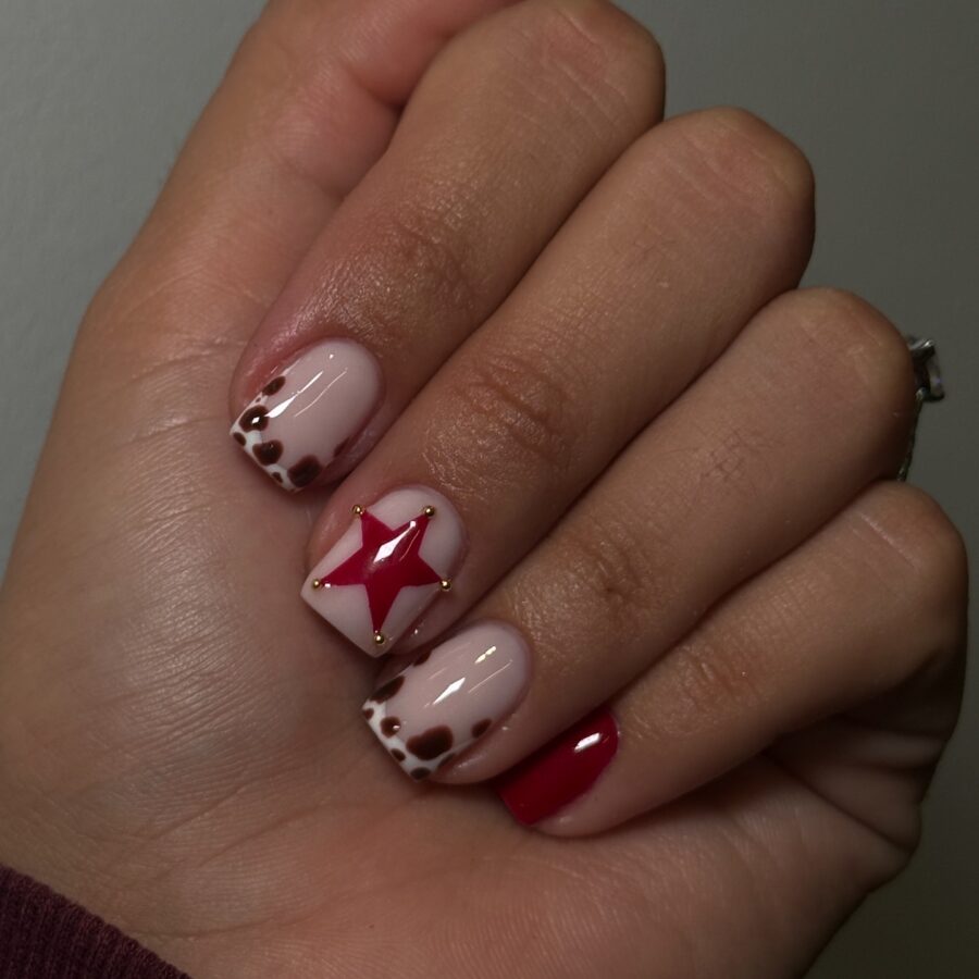 Chic cow print nails with a pop of red