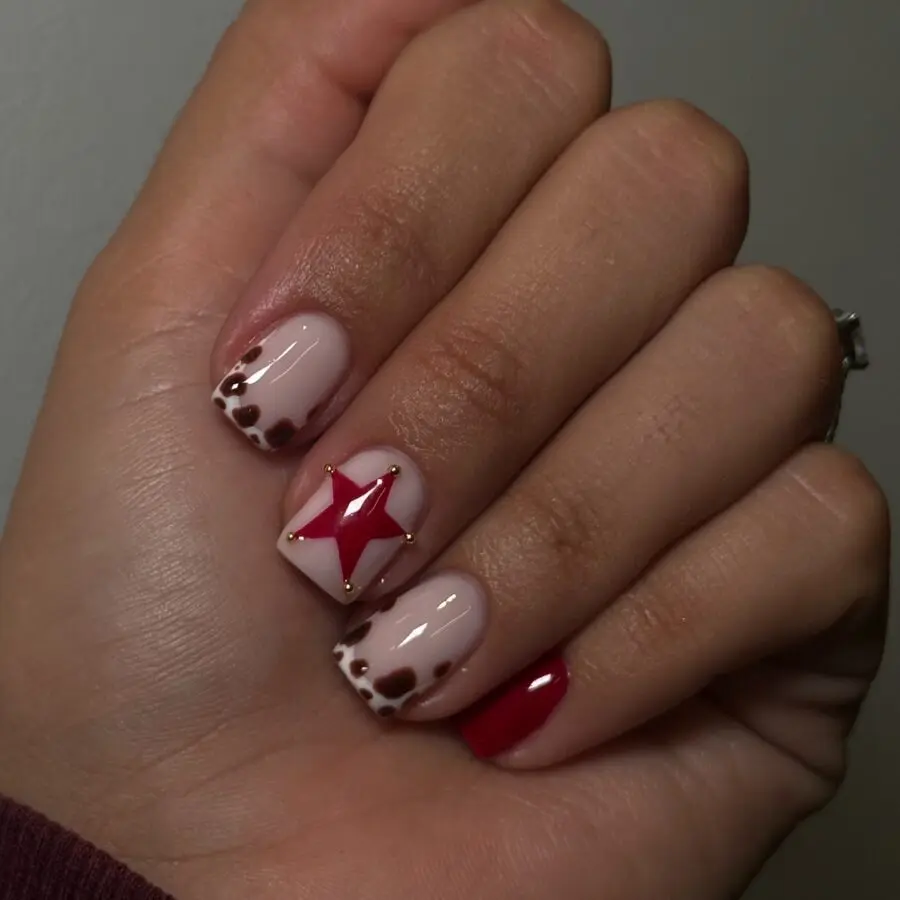 Chic cow print nails with a pop of red
