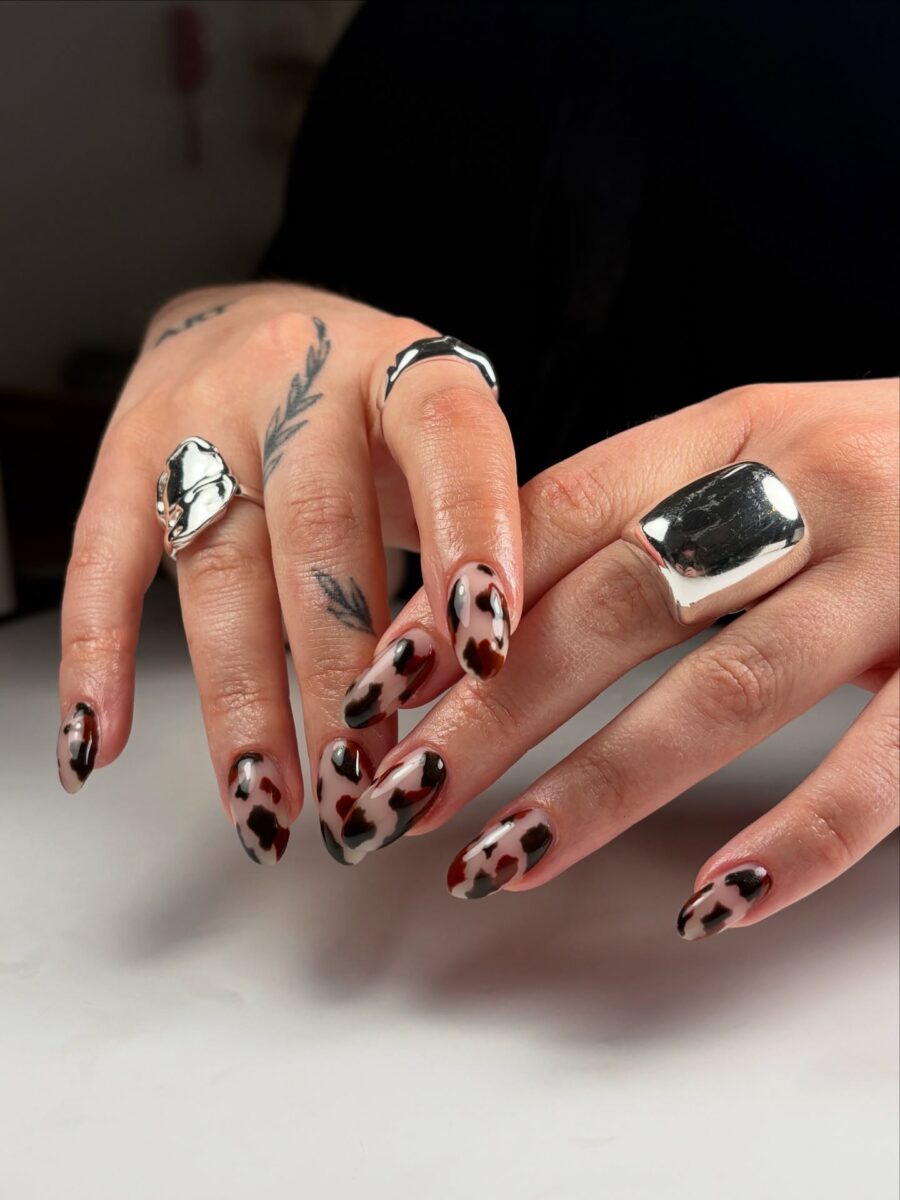 Stylish cow print nails with chic silver accents