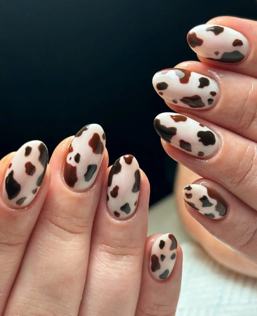 Chic cow print nail design for trendy vibes