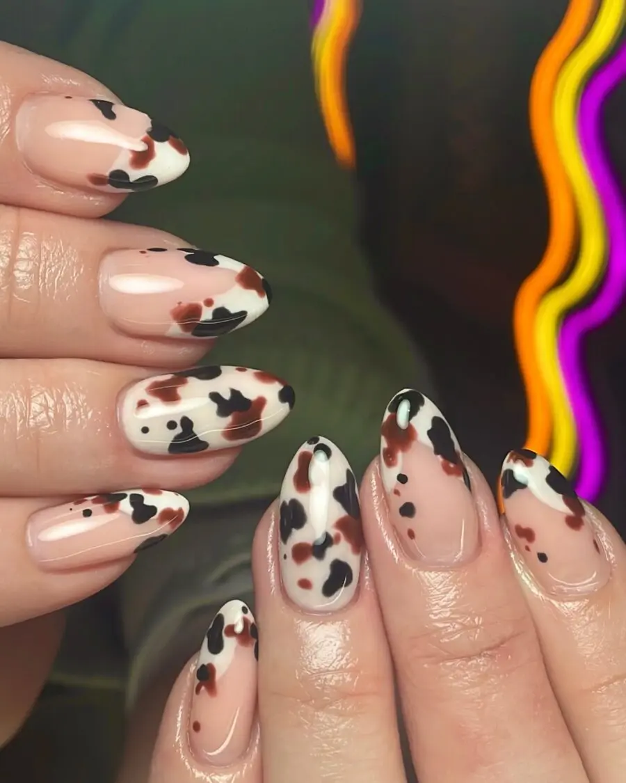 Trendy cow print nails with colorful accents
