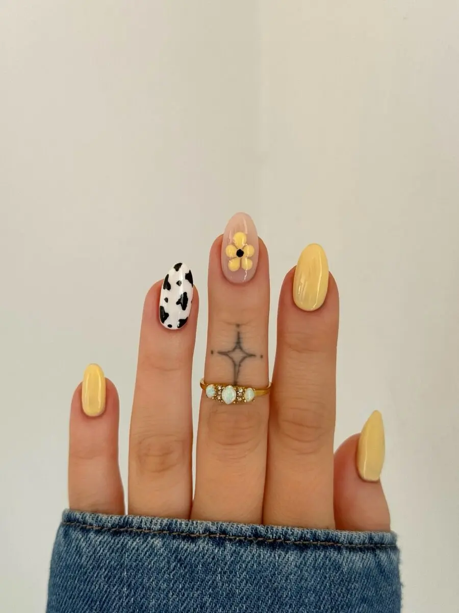 Charming cow print nails with a floral twist