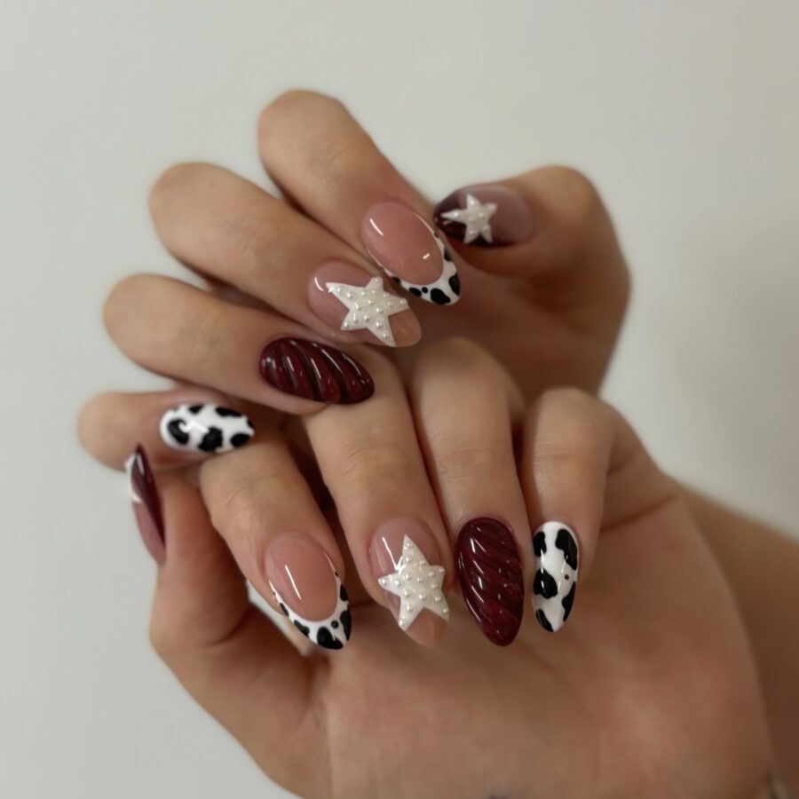 Chic cow print nails with star accents