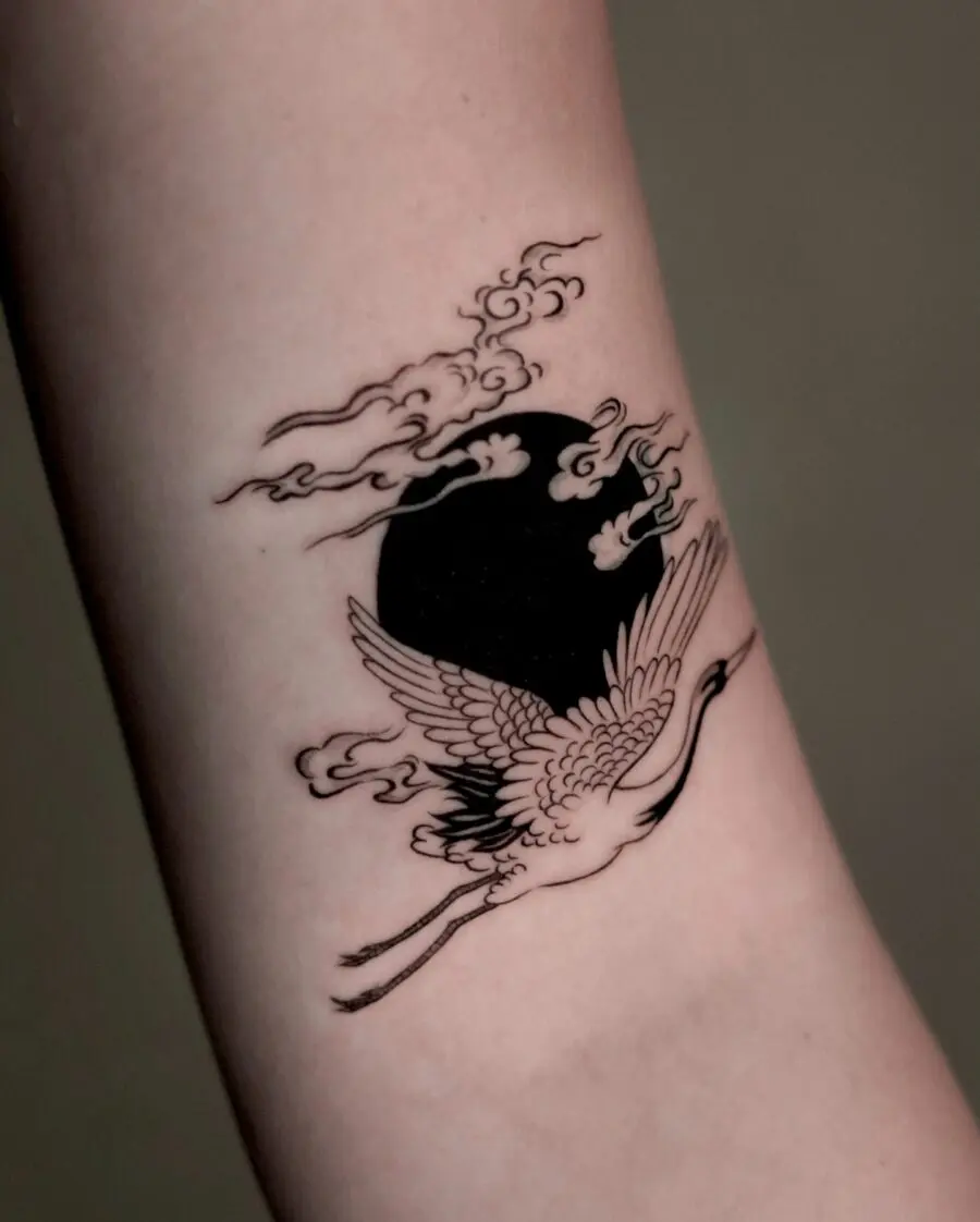 Elegant crane tattoo with clouds and moon