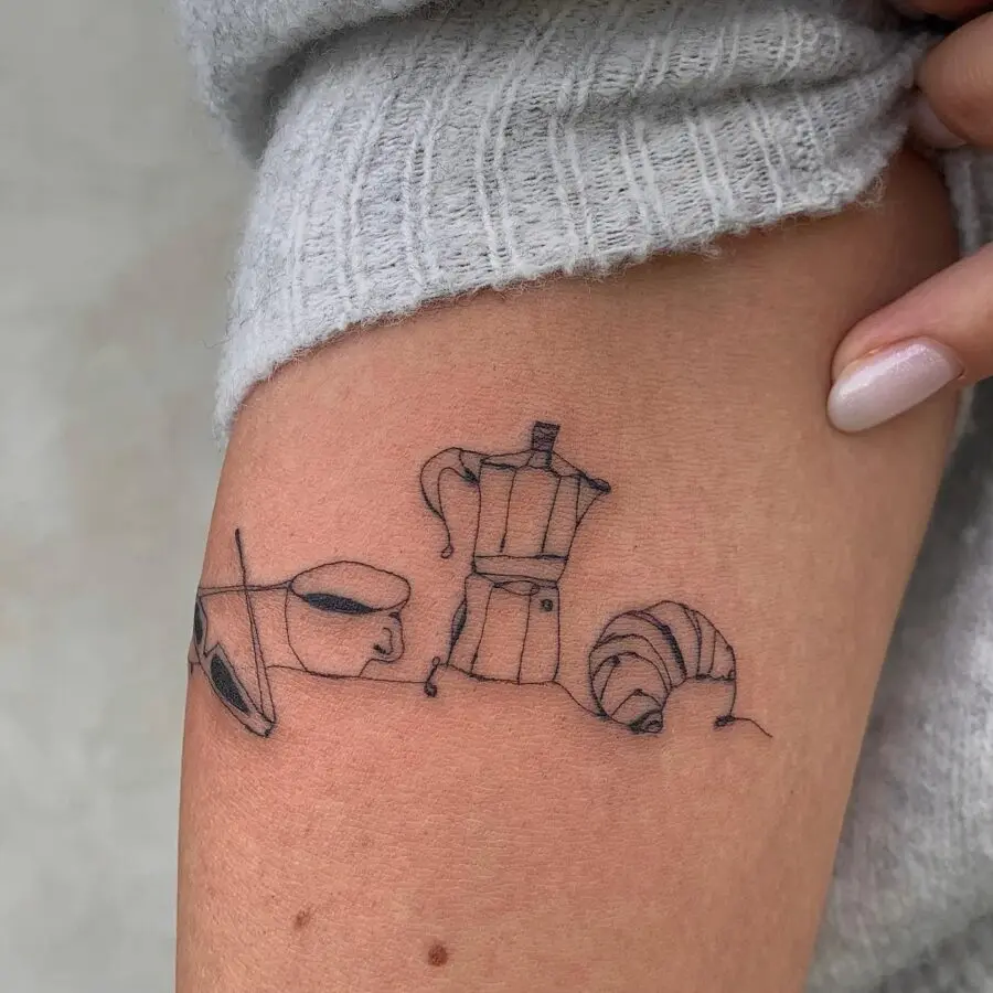 Charming croissant-inspired tattoo design on skin