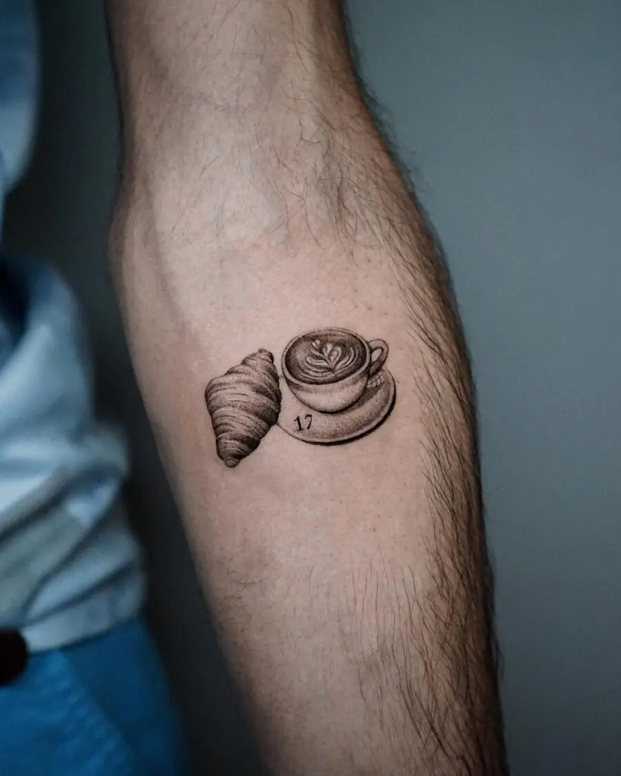 Charming croissant and coffee tattoo on arm