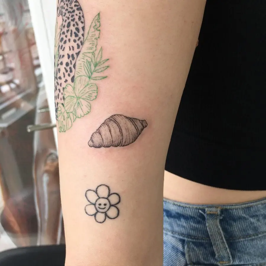 Charming croissant and flower tattoo combo