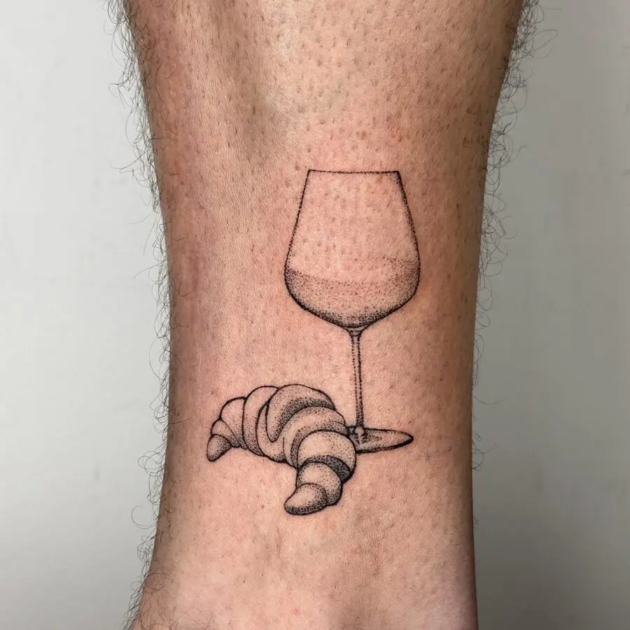 Chic croissant and glass tattoo design