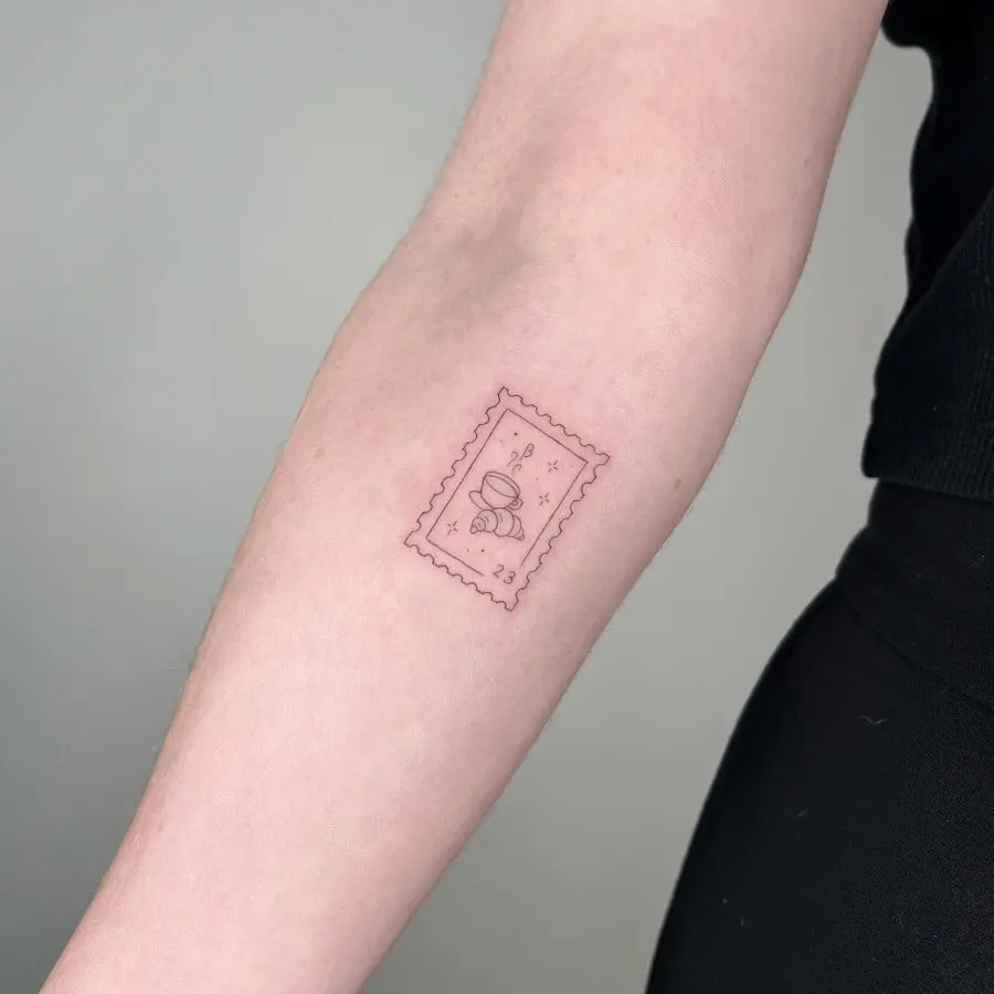 Elegant croissant tattoo resembling a vintage stamp