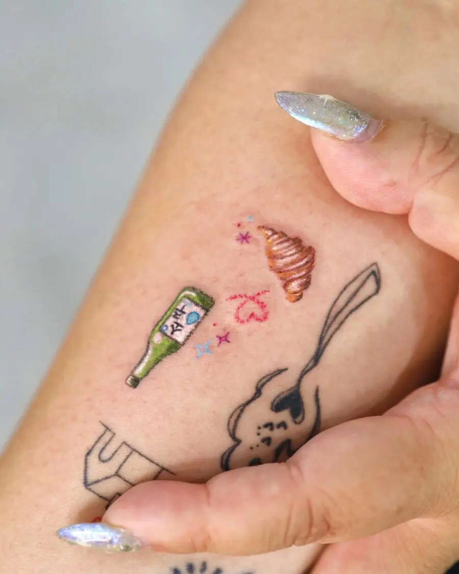 Colorful croissant tattoo with whimsical elements