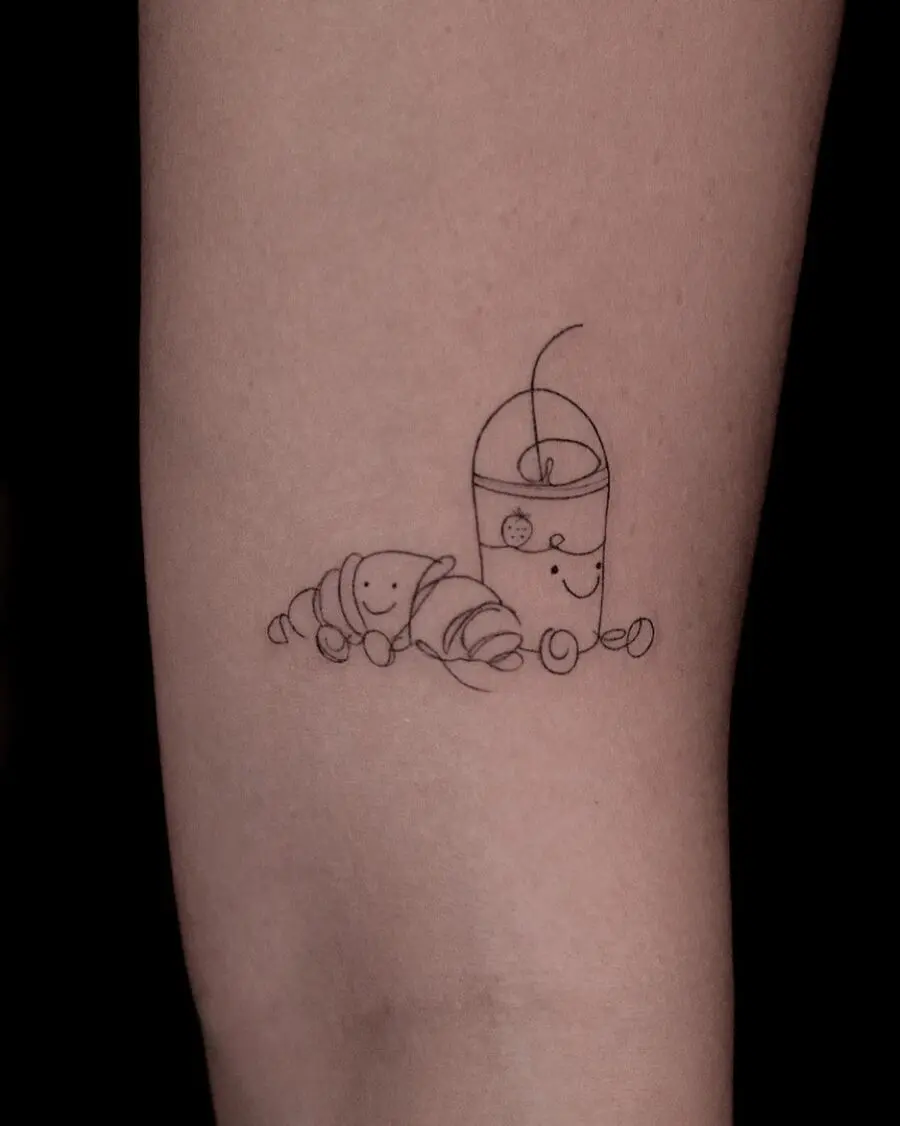 Charming croissant and drink tattoo design