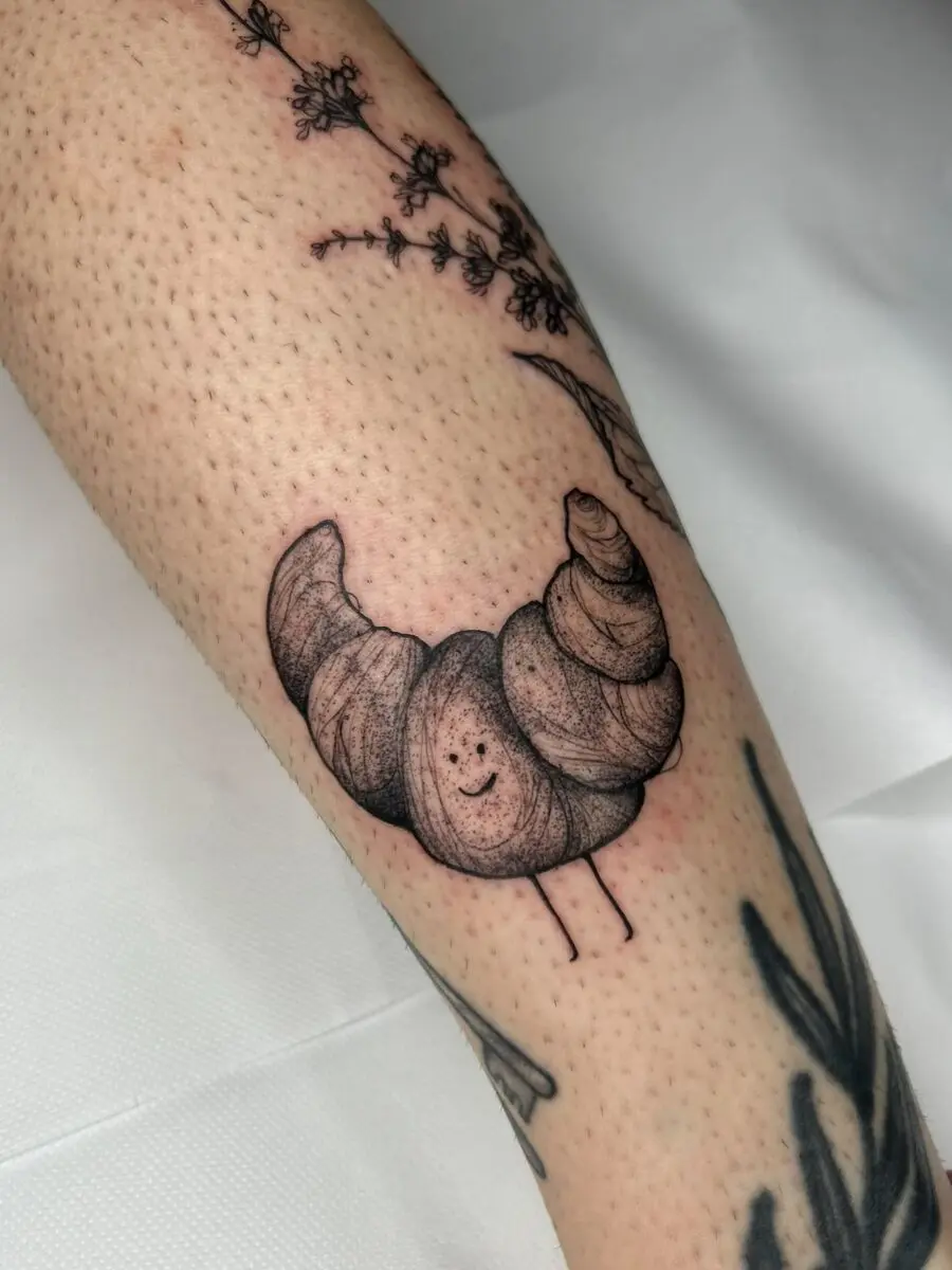 Charming happy croissant tattoo drawing