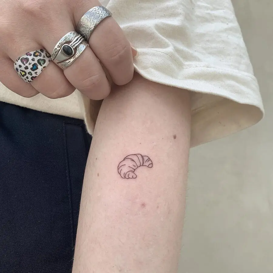 Minimalist Croissant Tattoo on Delicate Skin