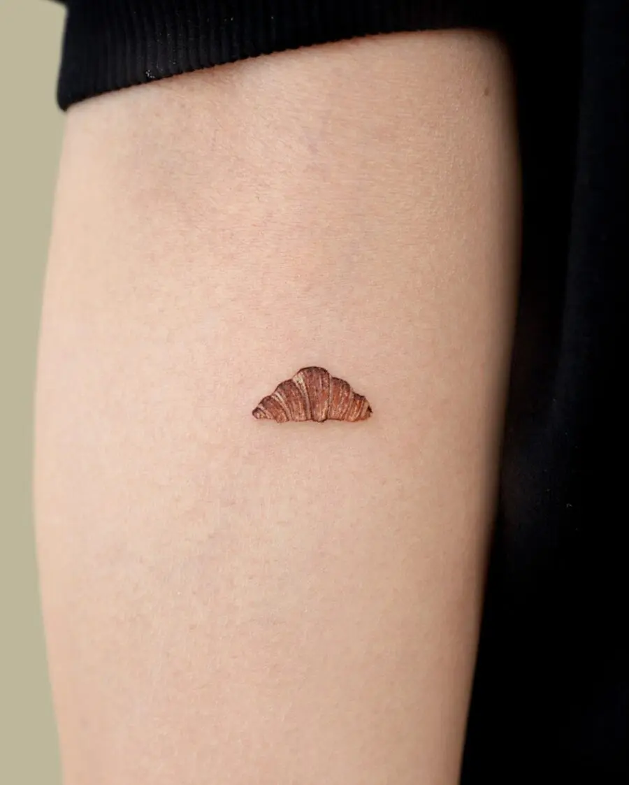 Charming croissant tattoo with rich details