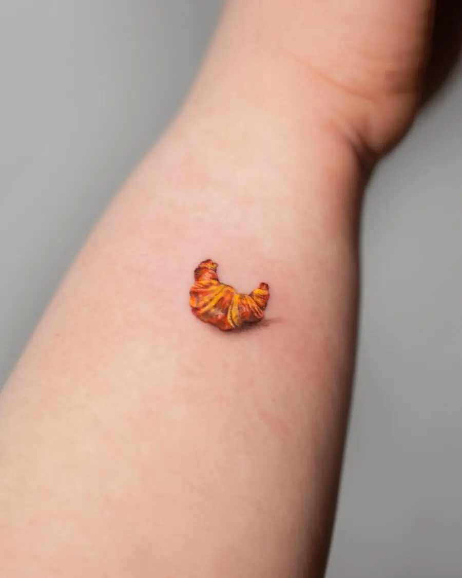 A Charming Croissant Tattoo on the Forearm