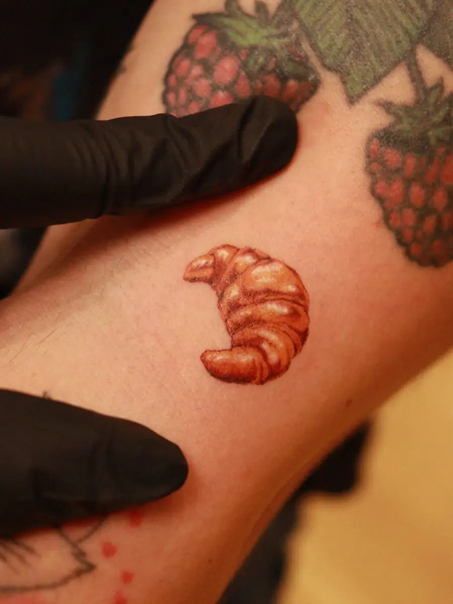 Charming croissant tattoo in lifelike detail