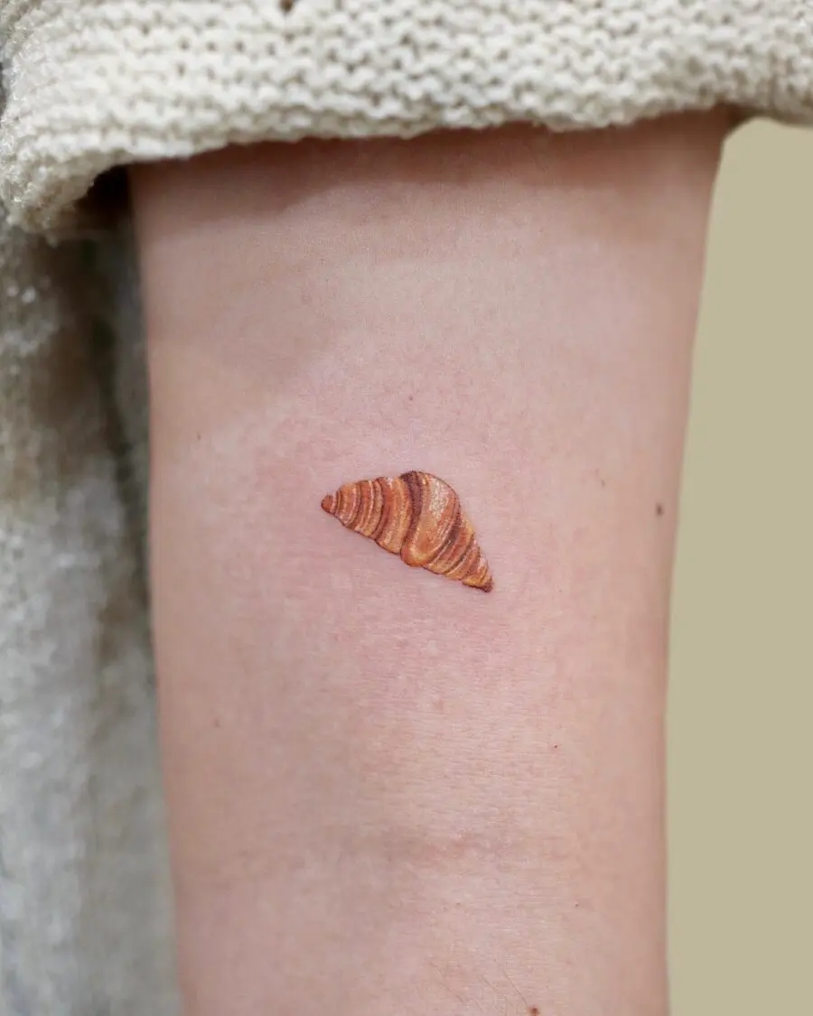 Charming croissant tattoo for food lovers