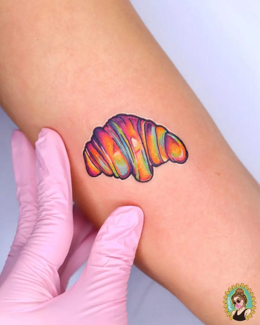 Colorful Croissant Tattoo with Artistic Flair