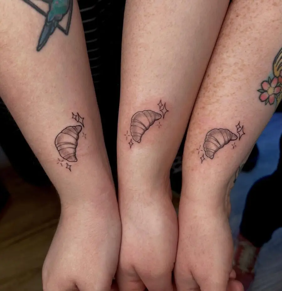 Charming minimalist croissant tattoo trio