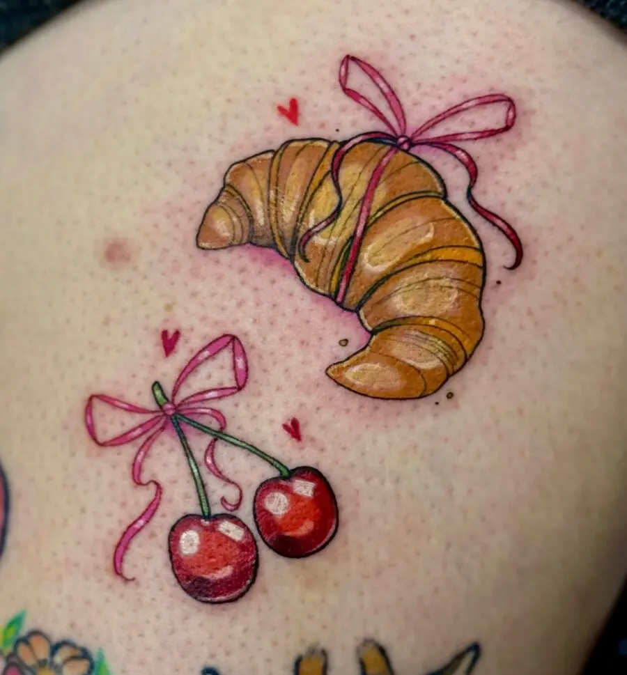 Delightful croissant and cherry tattoo design