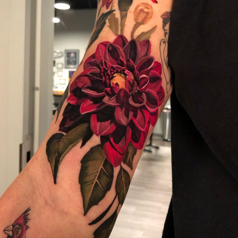 Vibrant red dahlia tattoo showcasing floral beauty