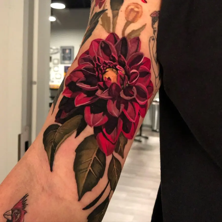 Vibrant red dahlia tattoo showcasing floral beauty
