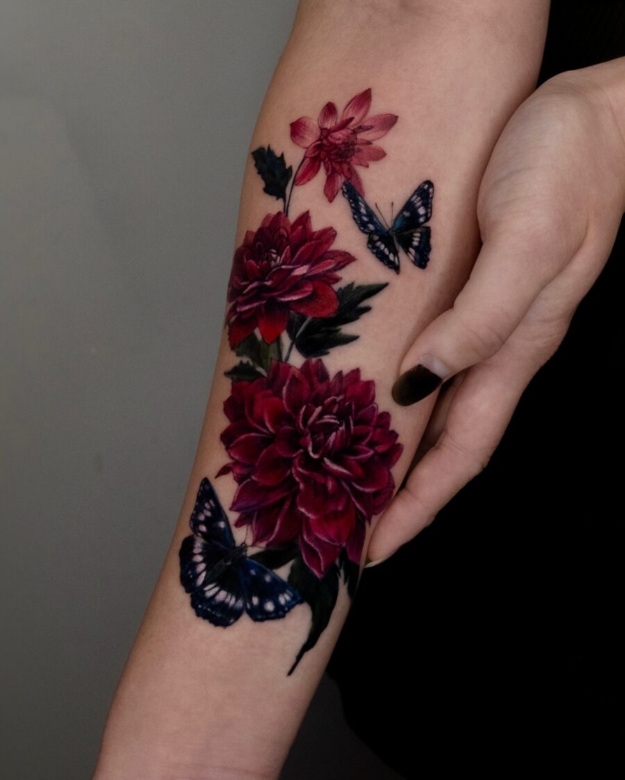 Vibrant dahlias alongside graceful butterflies tattoo