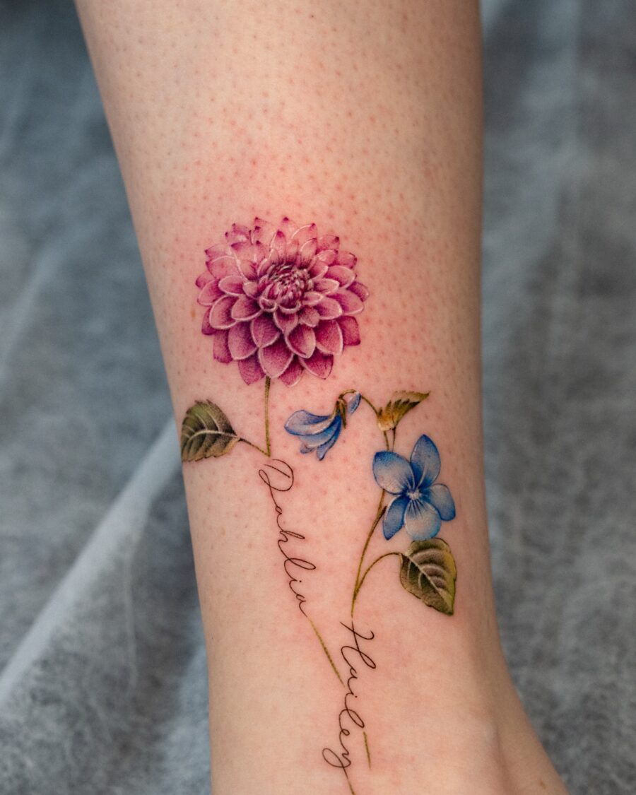 Vibrant dahlia and blue flower tattoo design