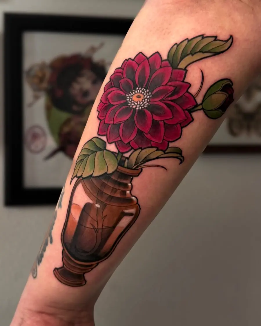 Vibrant dahlia tattoo in a vase design