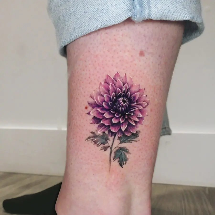 Elegant purple dahlia tattoo on the leg