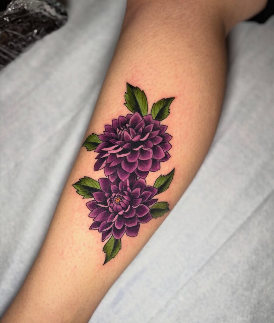 Stunning Purple Dahlia Tattoo with Lush Leaves