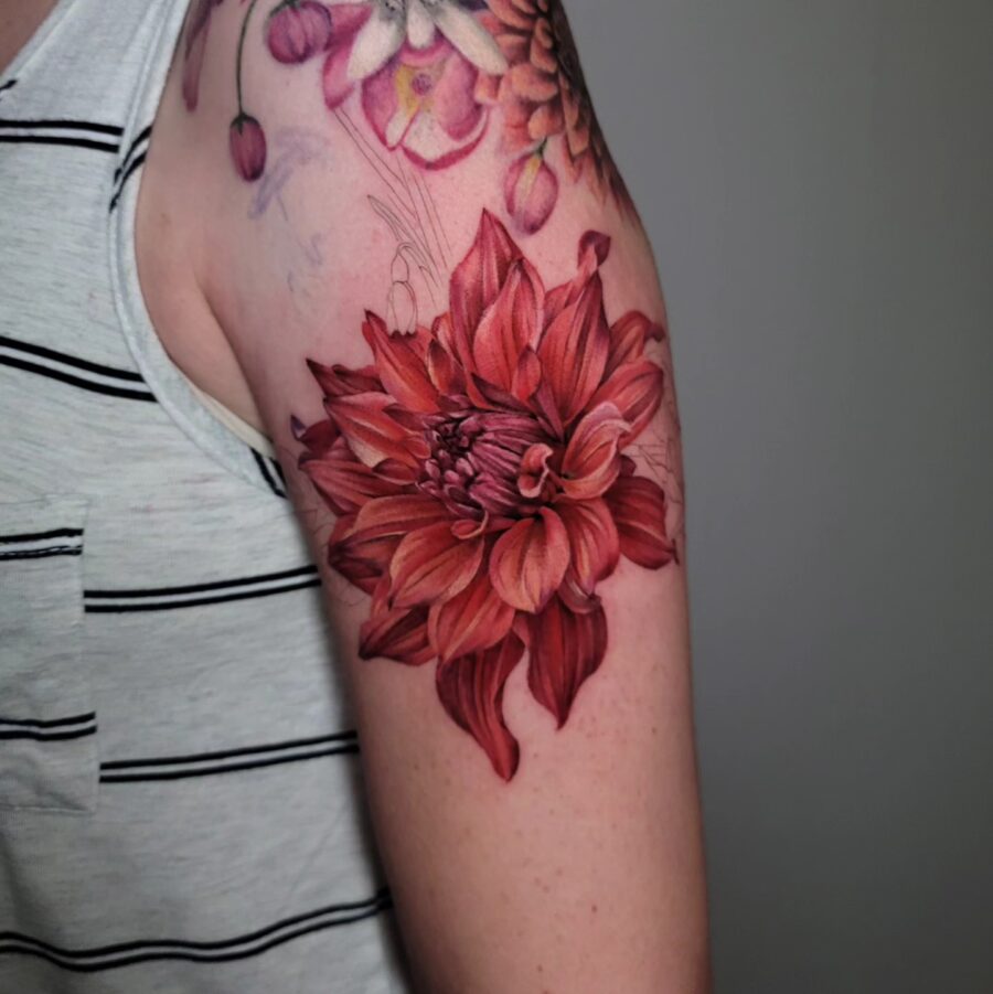 Vibrant dahlia tattoo showcasing rich red hues